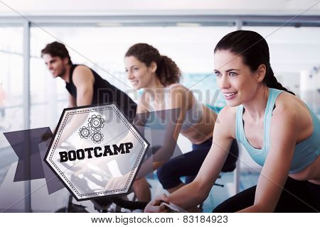 The word bootcamp and fit people in a spin class against hexagon