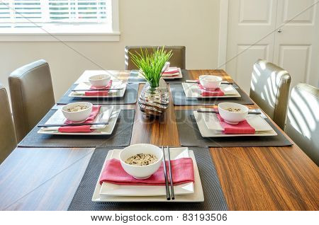 Contemporary dining room table set for dinner