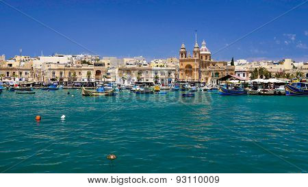 Maltese Fishing Village With Boats And Church