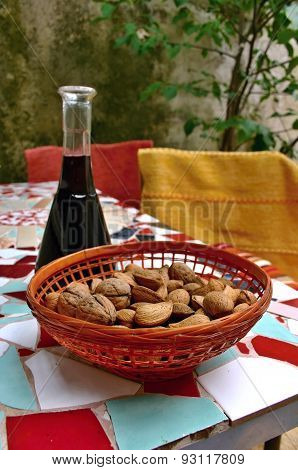 Almonds and walnuts in basket on mosaic table