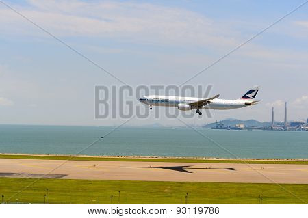 HONG KONG - JUNE 04, 2015: Cathay Pacific aircraft landing. Cathay Pacific is the flag carrier airline of Hong Kong, with its head office and main hub located at Hong Kong International Airport