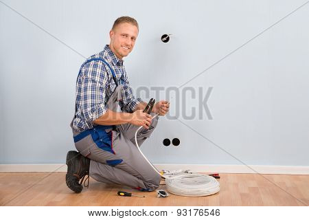 Electrician Stripping Wire In House