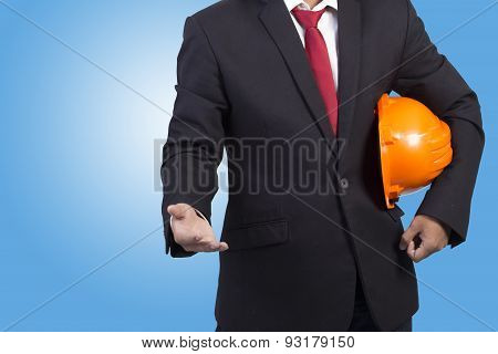 Engineer Holding Orange Helmet For Workers Security On Blue Background