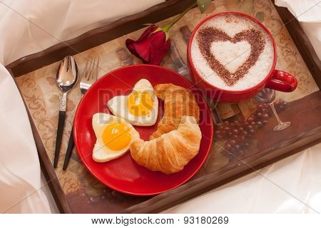 Breakfast in bed - Eggs, Croissant and coffee
