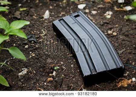 Airsoft gun magazine on the ground