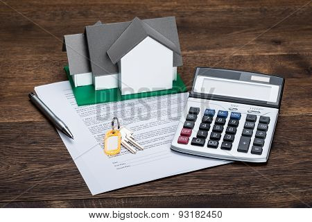 House Model On Contract Paper With Keys And Calculator