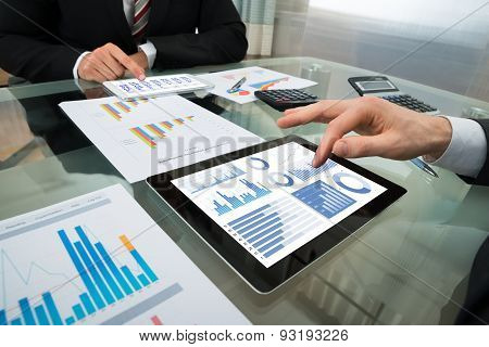 Two Businessman Working On Digital Tablet
