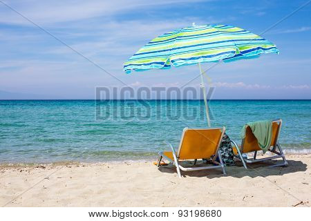 Background With Beach Chairs And Colorful Umbrella On Sandy Beach