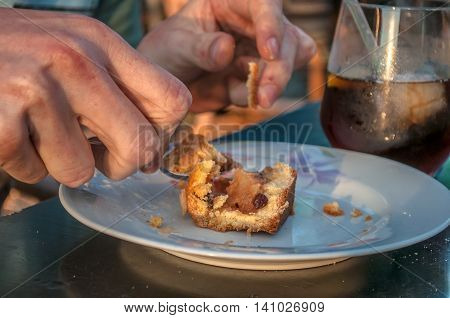 close-up of man eating a small slice of cake