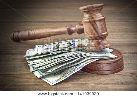 Judges Or Auctioneers Gavel And Money Stack On Wooden Background