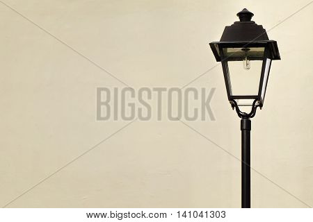 Garden Or Street Lamp Post In Victorian Style And White Wall In The Background