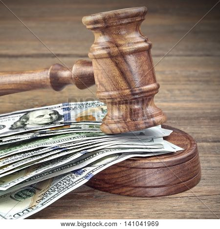 Judges Or Auctioneers Gavel And Money Stack On Wooden Background