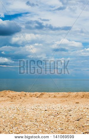 Sand And Shelly Beach And Dark Blue Clouds