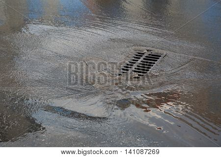 After heavy rain, the dirty water rushes into the flow of a large an underground reservoir
