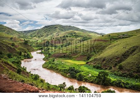 Red water of the river of Tsiribihina with mountains on the background, Madagascar