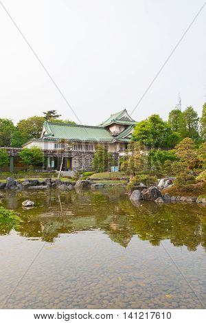 Toyama Castle With Beautiful Garden And Reflection In Water.