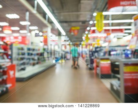 Blur eletronic department store with unrecognizable customers. Blurred background with bokeh