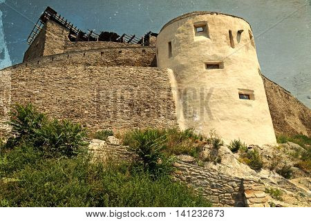 Old postcard with view of one part at the citadel ruins of Deva (Transylvania Romania). Built in 1250 is located at a height of 371 meters above the city.Vintage processing.