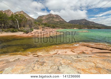 Honeymoon Bay is located near Coles Bay in Freycinet Peninsula. Freycinet National Park, is a paradise of pink granite mountains, white beaches and turquoise sea on Tasmanias east coast, Australia.