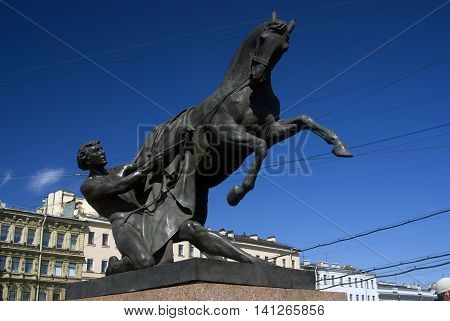 View of Horse tamers monument by Peter Klodt on Anichkov Bridge in Saint-Petersburg Russia. Popular touristic landmark.