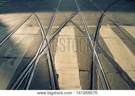 tram rails on pedestrian crosswalk; asphalt and steel on the street of canadian Toronto;