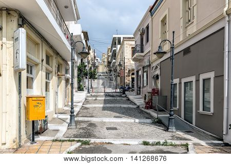 SITIA, CRETE, GREECE - JUNE 2016: Street with steps and traditional architecture of Sitia town in eastern part of Crete island, Greece