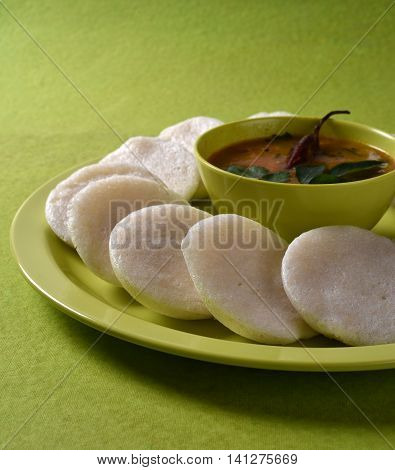 Idli With Sambar In Bowl On Green Background, Indian Dish : South Indian Favourite Food Rava Idli Or