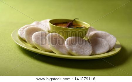 Idli With Sambar In Bowl On Green Background, Indian Dish : South Indian Favourite Food Rava Idli Or