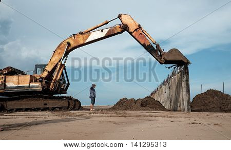 Excavator Build Breakwater At Beach