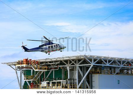 helicopter parking landing on offshore platform, Helicopter transfer crews or passenger to work in offshore oil and gas industry, air transportation for support passenger, ground service in airport.