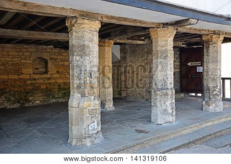 BURFORD, UNITED KINGDOM - JULY 20, 2016 - The old Tudor Market building leading to the Tolsey Museum Burford Oxfordshire England UK Western Europe, July 20, 2016.