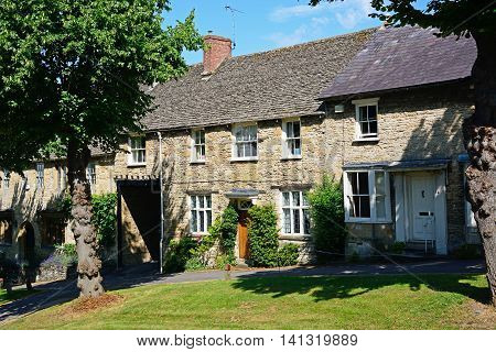 BURFORD, UNITED KINGDOM - JULY 20, 2016 - Cotswold cottages at the top end of The Hill shopping street Burford Oxfordshire England UK Western Europe, July 20, 2016.
