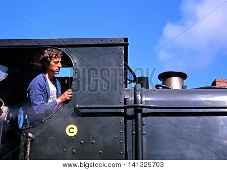 HIGHLEY, UNITED KINGDOM - JULY 18, 1993 - Engine driver in the cab of his steam locomotive Severn Valley Railway Highley Shropshire England UK Western Europe, July 18, 1993.