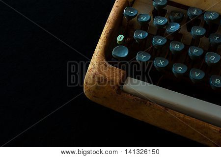 Typewriter Waiting for Inspiration. Vintage Rusty Typewriter Machine. Journalist Equipment. Typewriter Close Up Isolated on Black Background.