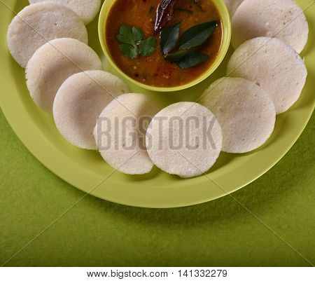 Idli With Sambar In Bowl On Green Background, Indian Dish : South Indian Favourite Food Rava Idli Or