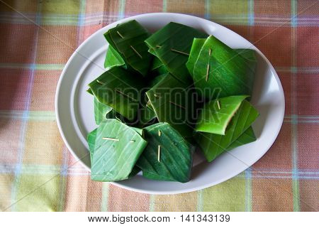 Thai style dessert made from Steamed Flour with Filling inside wrapped with banana leaf Khanom Sod-Sai