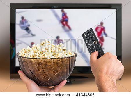 Man Is Watching Hockey Match On Tv