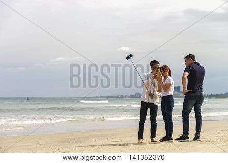 Young People Use Selfie Stick Iat China Beach In Danang