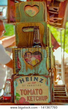CURITIBA , BRAZIL - MAY 12, 2016: nice wood boxes painted with some publicity, heinz ketchup advertisment painted in the biggest box, cocacola glass bottle placed inside of one box.