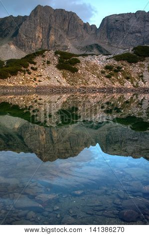 Reflection of rocks in Sinanitsa lake, Pirin Mountain, Bulgaria