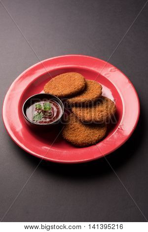 Indian chat item aloo or aalu tikki or tikiya or fried potato cake also known as ragda patties served with tomato ketchup, selective focus