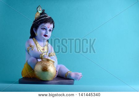 Hindu God Krishna on blue background. Greeting card Design. Space for Headline and Copy.