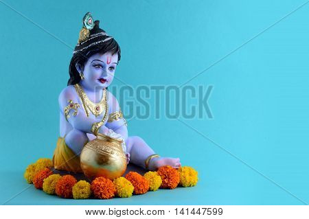 Hindu God Krishna on blue background. Greeting card Design. Space for Headline and Copy.