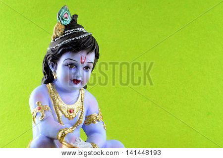 Hindu God Krishna on green background. Greeting