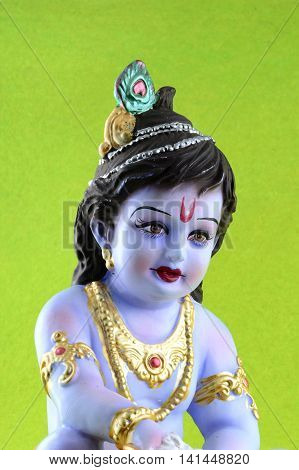 Hindu God Krishna on green background. Greeting