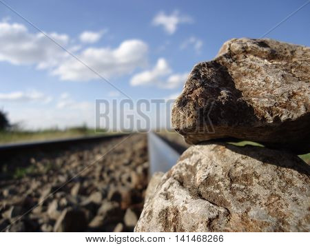 Upclose photo of rocks placed on a rail track.