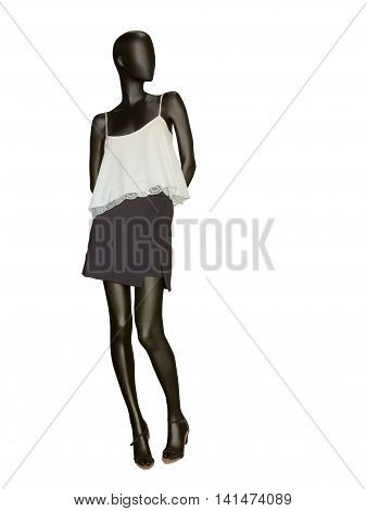 Female mannequin dressed in skirt and sleeveless top isolated on white background. No brand names or copyright objects.