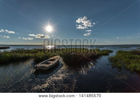 The wooden boat in canes in the evening August, rather hot for these latitudes.