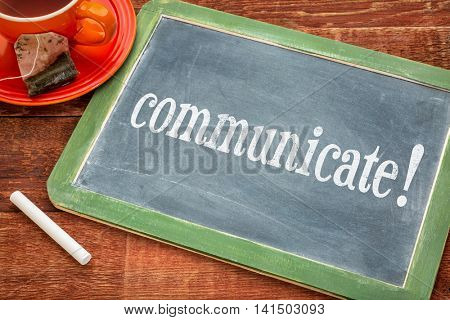 Communicate advice or reminder  - motivational text on a slate blackboard with chalk and cup of tea