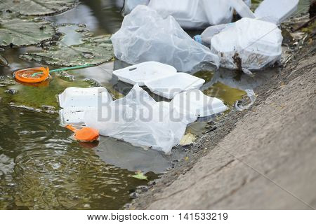 Garbage in the water / waste and garbage mismanagement concept